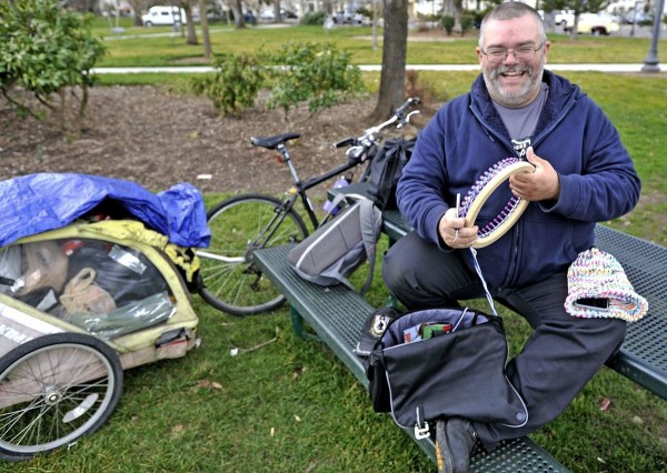 Homeless man loom knits hats for others in need.