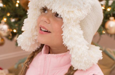 Knit a fun, fur-trimmed earflap hat in three sizes.