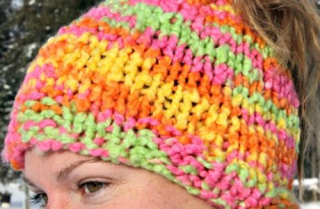 Knit a super simple ponytail hat worked flat.